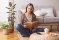 Peaceful young lady reading book. enjoying coffee on floor Royalty Free Stock Photo