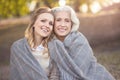 Peaceful young woman hugging aging mother at the picnic Royalty Free Stock Photo