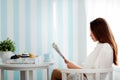 Peaceful young woman reading magazine at home Royalty Free Stock Photo