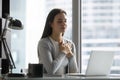 Grateful young woman feel thankful meditating at work