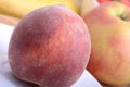 Peach, apple and strawberry on wooden plate Royalty Free Stock Photo