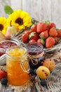Peach, blueberry and strawberry jams in glass jars