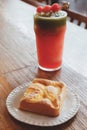 Peach chiffon cake on the white plate and cold blended watermelon with ice and green tea smoothie drink on the wooden table at the Royalty Free Stock Photo