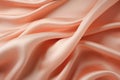 Peach-colored silk fabric, delicate satin with soft pleats