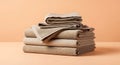 A neatly stacked pile of beige textiles, including folded blankets and towels, rests Royalty Free Stock Photo