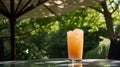 Peach Cooler Cocktail on Outdoor Table with Umbrella Shade in Garden Royalty Free Stock Photo