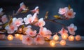 Peach flowers and candle on wooden background. Selective focus