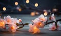 Peach flowers and candle on wooden background. Selective focus