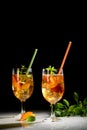 Peach fresh tea with ice, peach summer mocktail on a black background Royalty Free Stock Photo