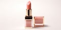 An peach fuzz color lipstick in a golden and pink case with its cap next to it on a white background. Make up a product