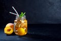 Peach ice tea drink on dark background with mint and ice Royalty Free Stock Photo