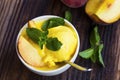 Peach and mango sorbet closeup with mint leaves Royalty Free Stock Photo