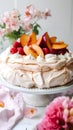 Peach Pavlova cake with fresh peaches and raspberries on a white background