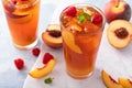 Peach and raspberry iced tea or cocktail Royalty Free Stock Photo