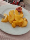 Peach sliced to eat easily on a plate and also a slice of fig summer fruits