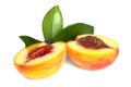 Peach sliced into two halves with leaf on white background isolated close up