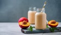 Peach smoothie in glass bottle with paper straw. Tasty and healthy beverage. Delicious summer drink