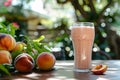 Peach smoothie or milkshake with fruits on table