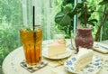 Peach tea and blueberry smoothie with tasty butter cake for teatime in cafe