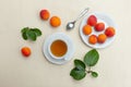 Peach tea in white cup with fresh peaches flatlay on the table Royalty Free Stock Photo