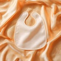 PeachColored Baby Bib on Soft Fabric Royalty Free Stock Photo