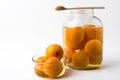 Peaches canned in a glass bowl and in a jar on a white background Royalty Free Stock Photo