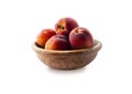 Peaches isolated on white background close-up. Macro. Peaches in a wooden bowl Royalty Free Stock Photo