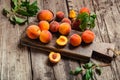 Peaches with leaves on wooden table with peach in halves. Ripe juicy peaches. Harvest of peaches for food or juice. Fresh organic Royalty Free Stock Photo