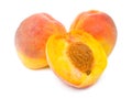 Peaches and a peach half Royalty Free Stock Photo