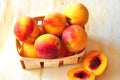 Peaches are in a small basket