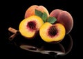 Peaches, whole and cut on a black mirror background Royalty Free Stock Photo