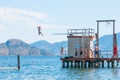 Children jump off diving board into Okanagan Lake at Swim Bay