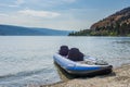 PEACHLAND, CANADA - AUGUST 01, 2020: blue inflatable kayak by the okanagan lake on a warm summer sunny day