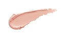 Peachy pink color correcting concealer smear smudge swatch isolated on white background. Thick cream texture