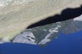 The peak of Grossglockner mountain is reflected in the water collected from the melting Pasterze glacier. Royalty Free Stock Photo