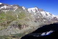 The peak of Grossglockner mountain is reflected in the water collected from the melting Pasterze glacier.