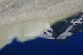 The peak of Grossglockner mountain is reflected in the water collected from the melting Pasterze glacier. Royalty Free Stock Photo