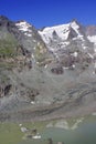 The peak of Grossglockner mountain is reflected in the water collected from the melting Pasterze glacier.