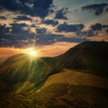 Peak of the hill and sunset rays Royalty Free Stock Photo