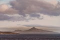 Peak on island of Wollaston archipelago under cloudscape, Cape Horn, Chile
