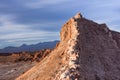 A peak in moon valley in the atacama desert (driest desert on earth) is bathed in the light of the setting sun in front of a storm Royalty Free Stock Photo