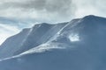 Peak of the Mountain. Beautiful landscape on the cold winter day. View of high mountains with snow white peaks. Royalty Free Stock Photo