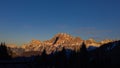 The peak of the mountains of the dolomites during sunset. High mountain landscape of the Dolomites in winter. Fantastic orange