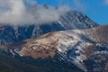 The peak of Mt. Quandary peaking from behind low clouds near Breckenridge, Colorado.