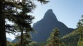 A peak rises above the forest in Glacier National Park.