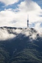 A peak on Vitosha mountain in Bulgaria surrounded by white clouds like mist. Blue sky with clouds. Beautiful landscape. Royalty Free Stock Photo