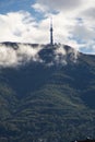 A peak on Vitosha mountain in Bulgaria surrounded by white clouds like mist. Blue sky with clouds. Beautiful landscape. Royalty Free Stock Photo