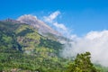 The peak of Volcano In Indonesia, showing ash and burnt landscape of recent eruption sliding down one side