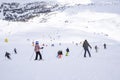 The peaks of the Alps mountains covered with snow. the ski slopes crowded with skiers on a sunny winter day