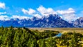 The peaks of The Grand Tetons behind the winding Snake River viewed from the Snake River Overlook